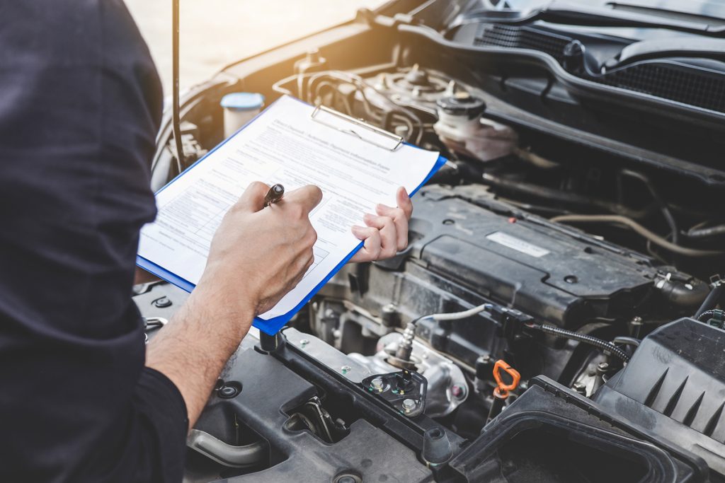 technician performing vehicle maintenance