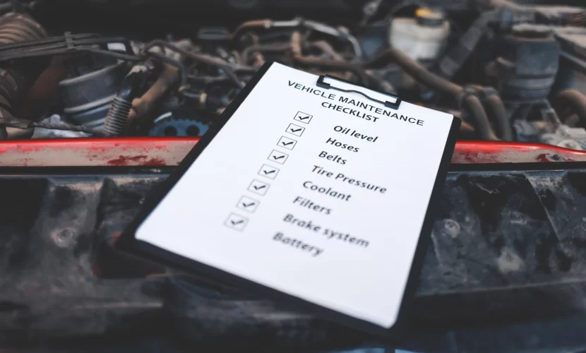 Close-up view of a clipboard with a vehicle maintenance checklist